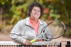 Former SU tennis player Abbe Seldin, who faced gender discrimination as a tennis player in high school, poses with a tennis racket.  